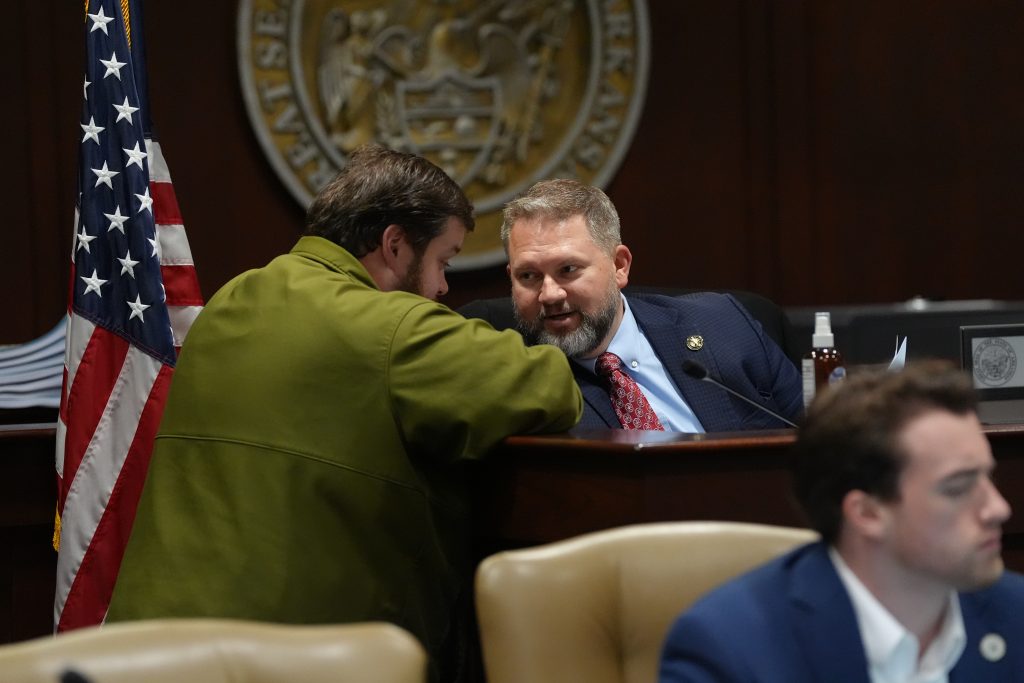 Senator Dotson speaking with Senator Gilmore before a committee meeting