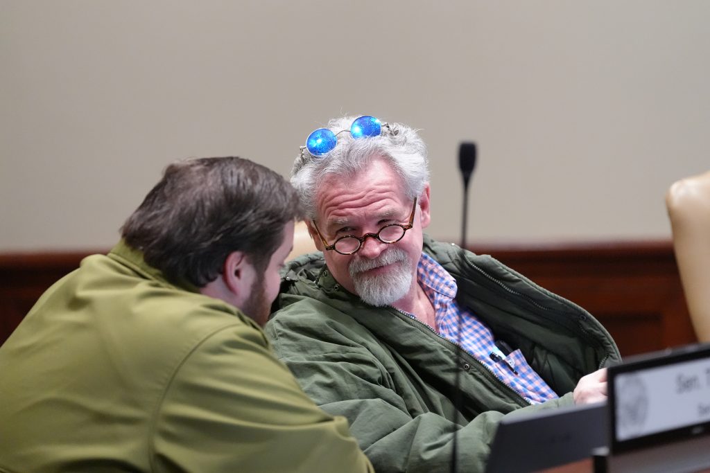 Senator Clark talks with Senator Gilmore during a committee meeting