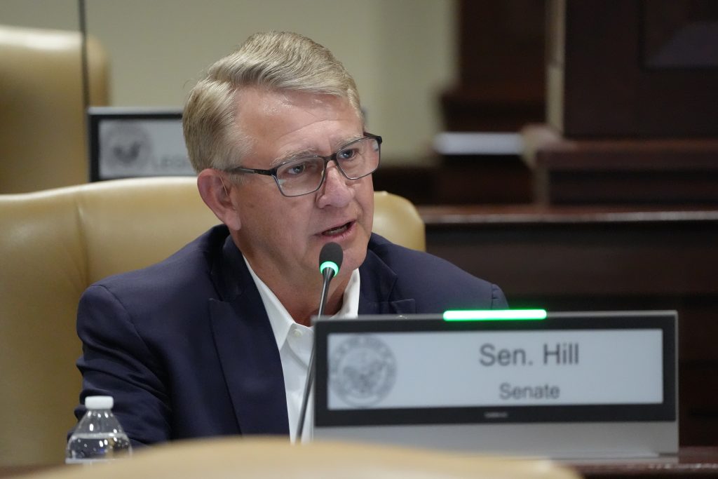 Senator Hill asks a question during a committee meeting.