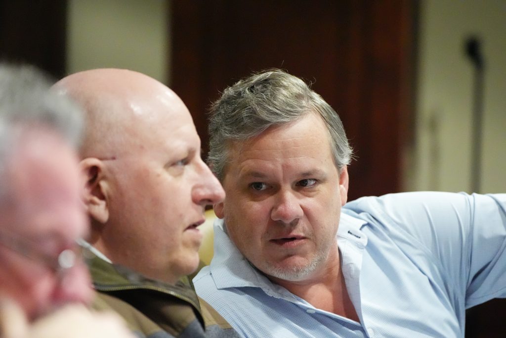 Senator Flippo speaks to Senator Payton during a committee meeting