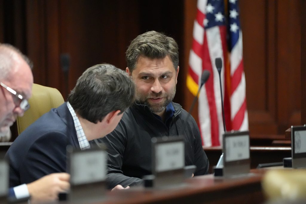 Senator Dismang talks with Senator Tucker before a committee meeting
