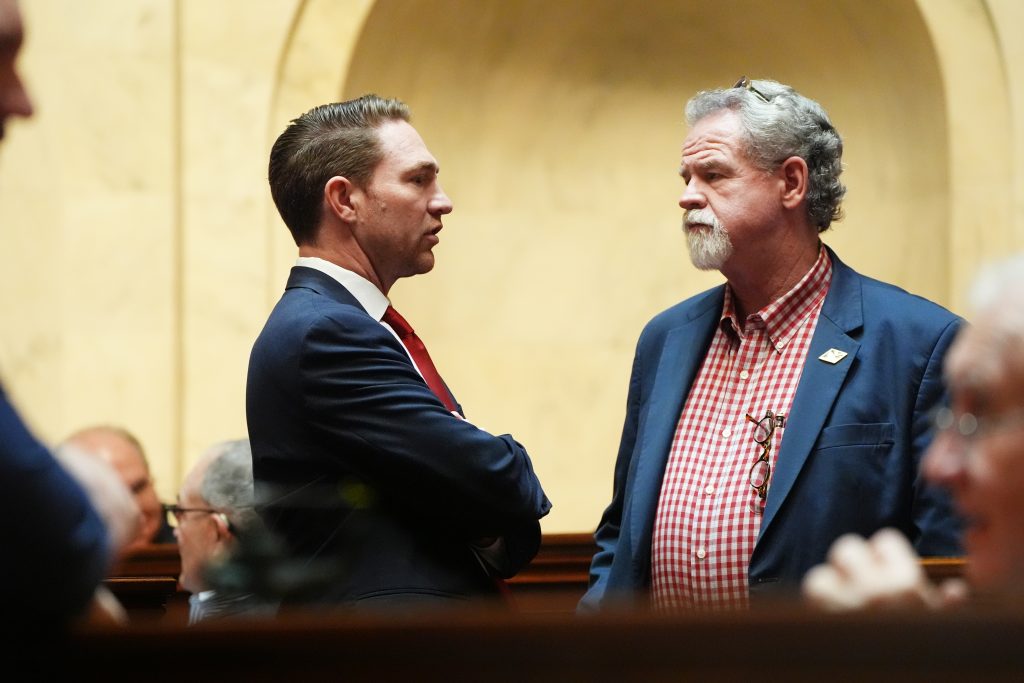 Senator Dees speaks with Senator Clark on the floor of the Senate Chamber