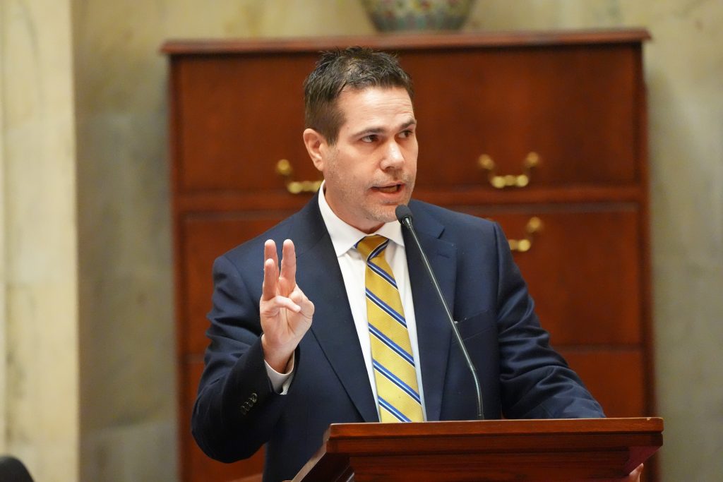 Senator Simon gestures while speaking in the Well in the Senate chamber