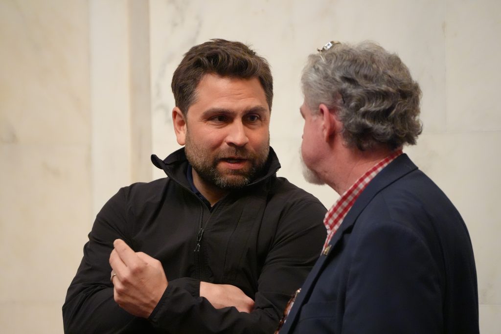 Senator Dismang talks with Senator Clark in the Senate chamber