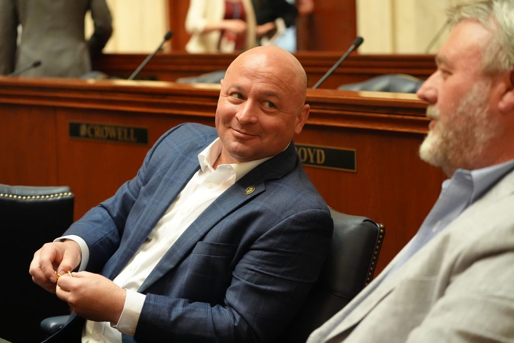 Senator McKee smiles while talking with Senator Brad Johnson