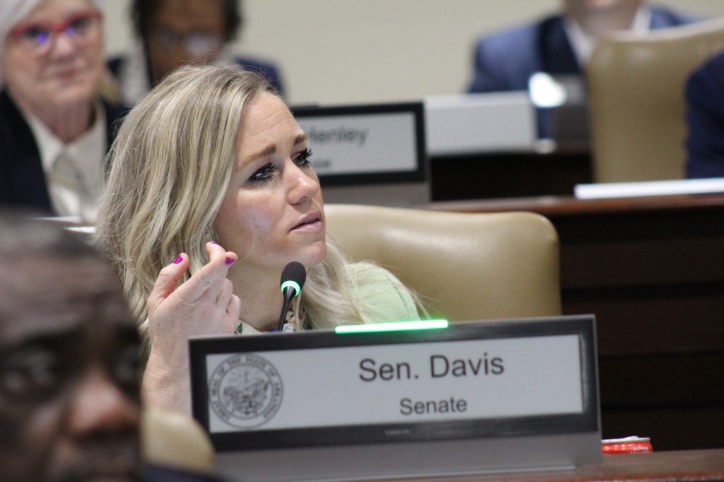 Senator Davis asks a question in a committee meeting.
