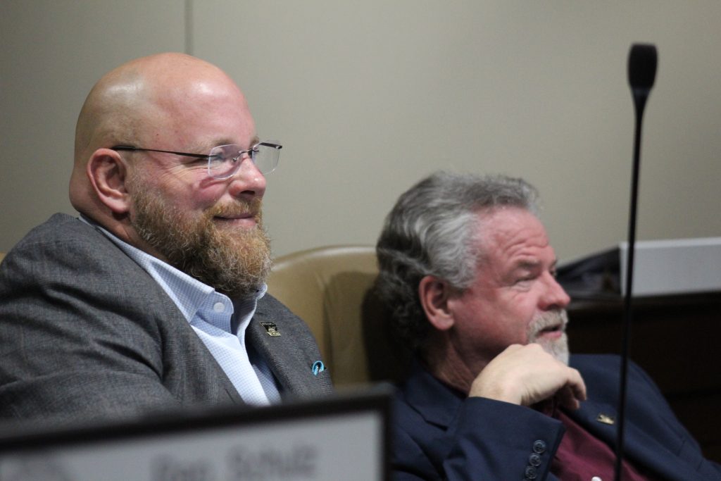 Senator Crowell smiles while listening at a committee meeting