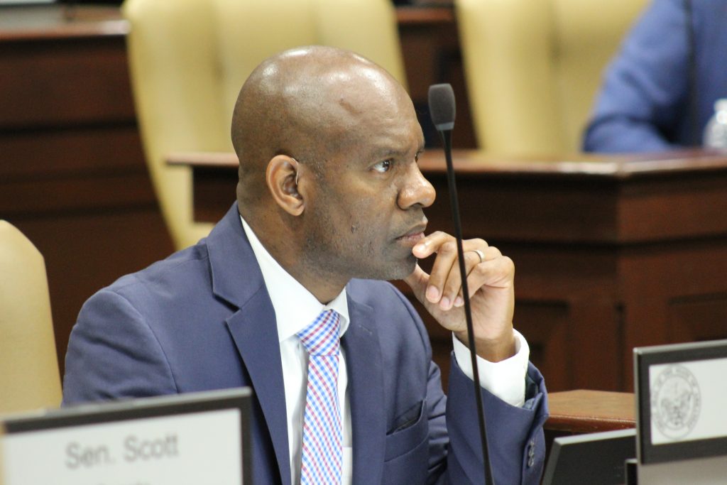 Senator Fred Love listens to testimony during a committee meeting