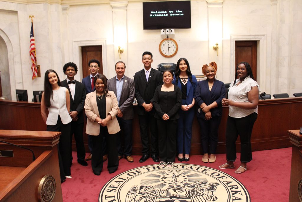 Senator Petty poses with a group of students representing the Boys and Girls Clubs of Benton County in the Senate chamber.