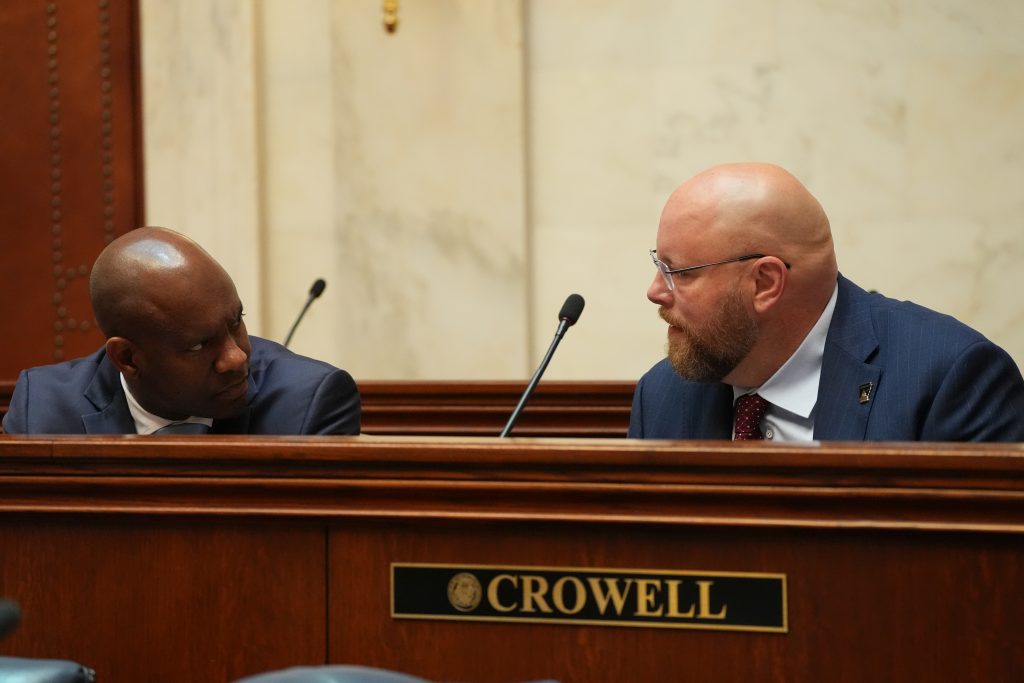 Senators Love and Crowell speak while seated in the Senate chamber