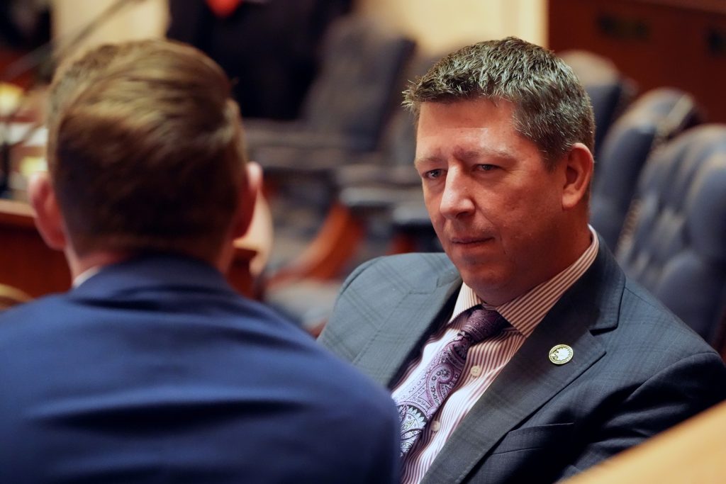 Senator Bryant listens to a colleague in the Senate chamber