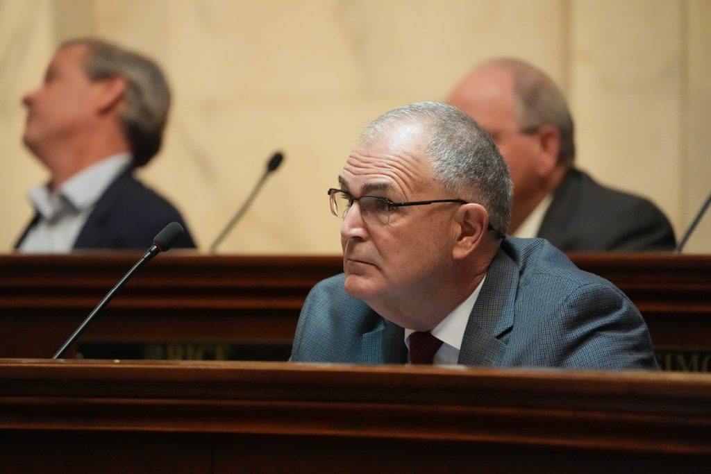 Senator Stone listens at his desk in the Senate chamber