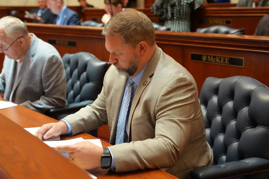 Senator Dotson reads papers at his desk in the Senate chamber