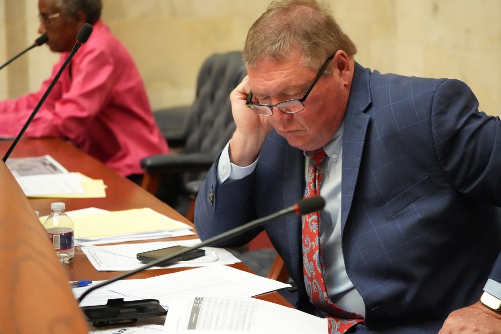 Senator King reads documents at his desk in the Senate chamber.