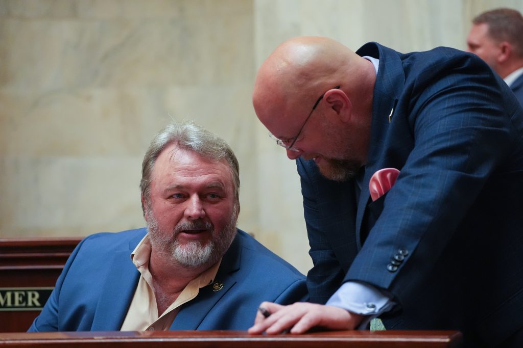 Senators Blake Johnson and Steve Crowell talk in the Senate chamber
