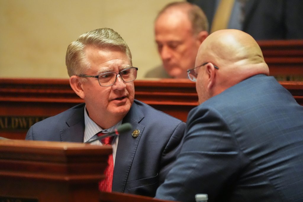 Senator Hill talks with Senator Crowell in the Senate chamber
