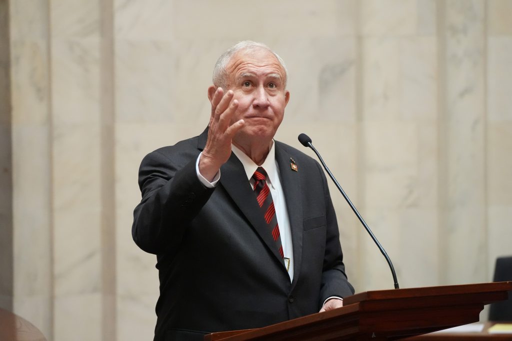 Senator Wallace gestures to the public gallery while speaking in the Senate chamber.