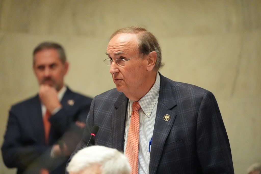 Senator Mark Johnson speaks in the Senate chamber. Senator Leding is seen in the background.