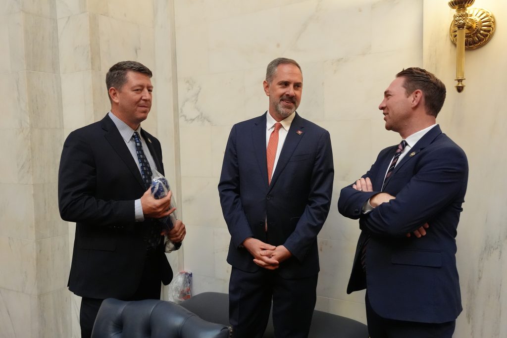 Sens Bryant, Leding, and Dees talk in the back of the Senate chamber