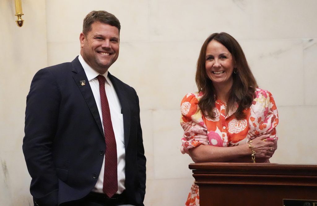 Senator Hester and Senator Irvin smile while standing in the Senate chamber