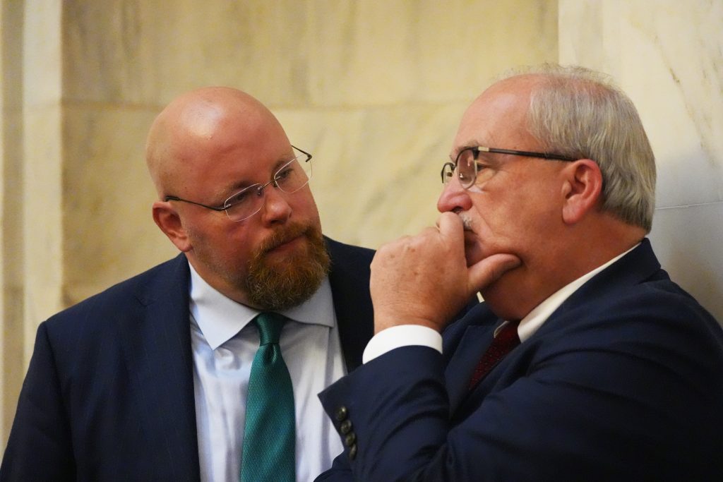 Senators Crowell and Hammer in conversation in the Senate chamber.