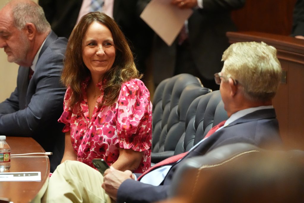 Senator Irvin smiles while talking with a colleague in the Senate chamber