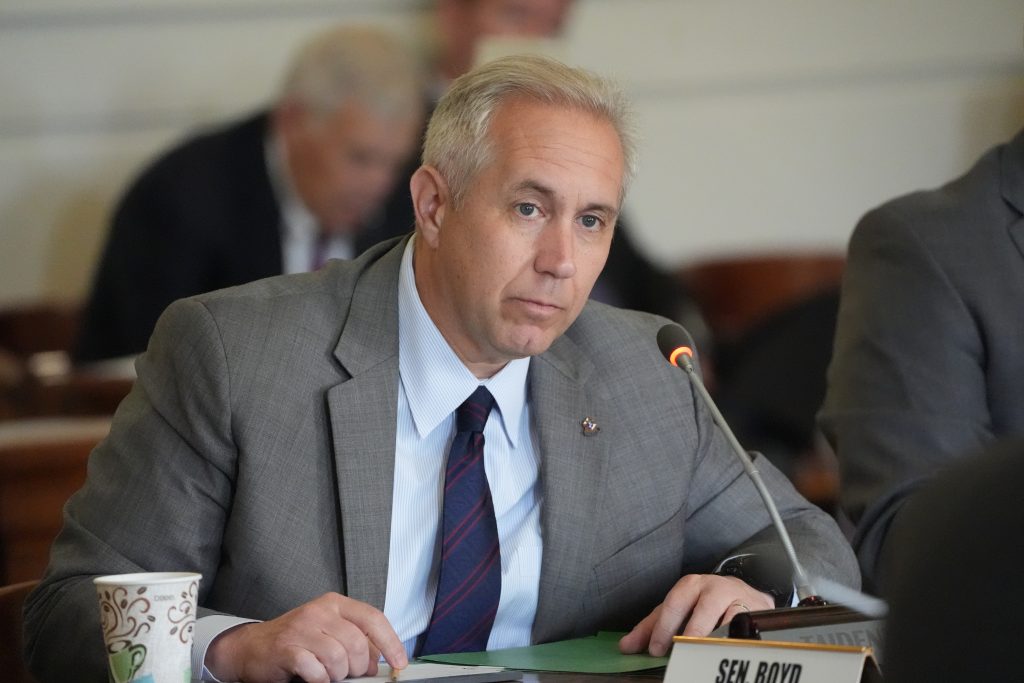 Senator Boyd listens to testimony in a committee meeting in the Old Supreme Court room