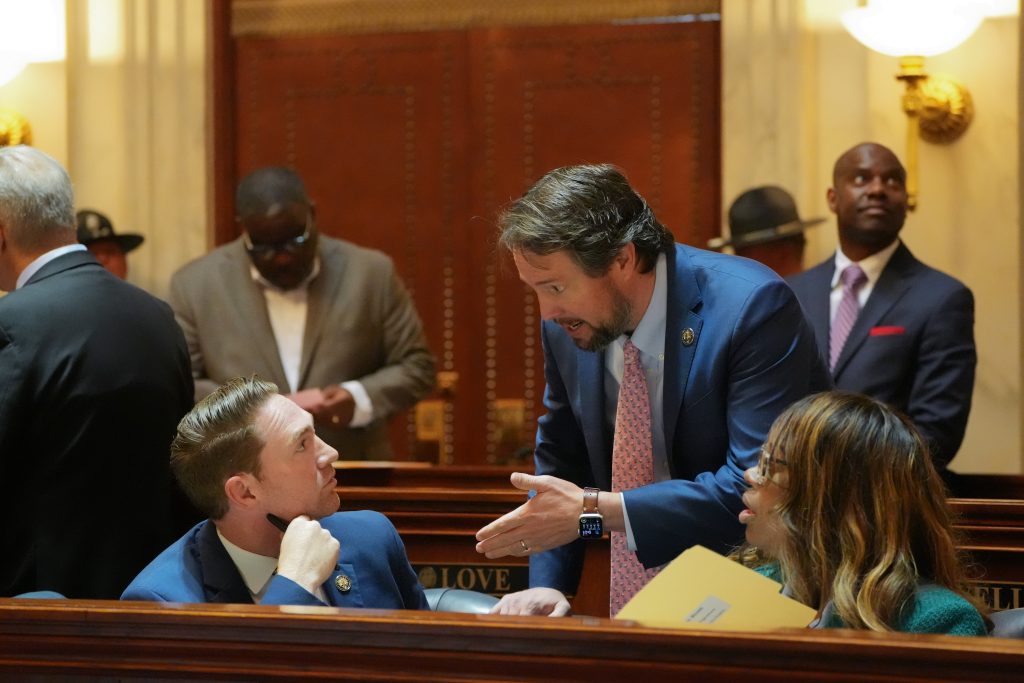 Sens Dees and Tucker talk in the Senate chamber