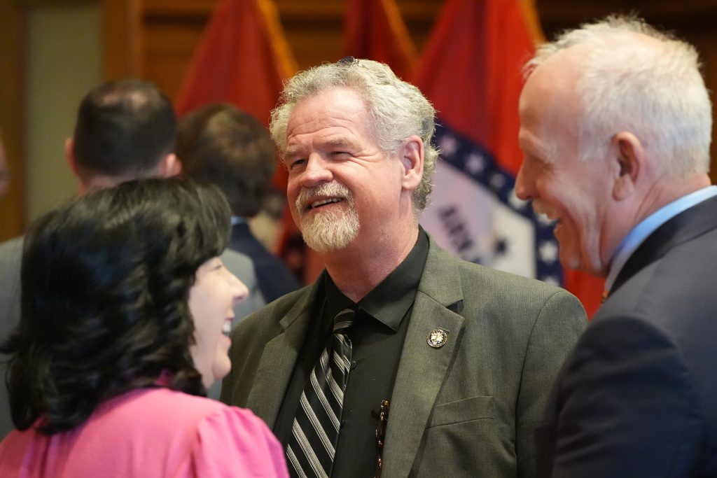 Senator Clark laughs with colleagues before a press conference