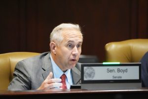 Senator Boyd speaks from the podium during the Autism Task Force meeting
