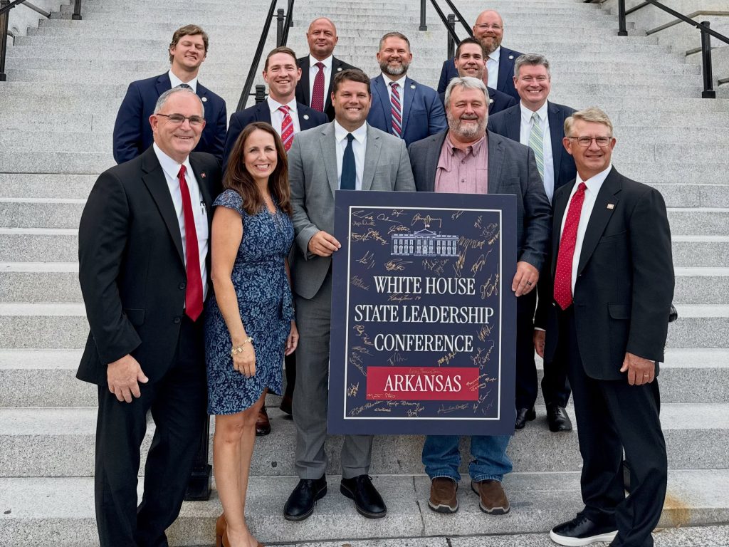 Group of senators pose on steps with a sign reading "White House State Leadership Conference Arkansas."