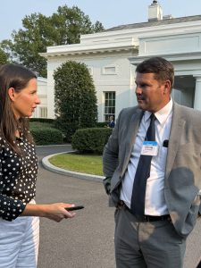 Senator Bart Hester talks with a woman outside of the White House