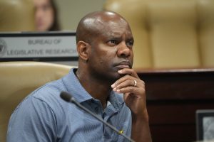 Senator Fred Love listens during committee testimony